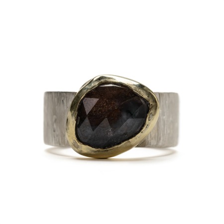 Heavy silver ring with a facetted Iolite Sunstone set in 14K gold